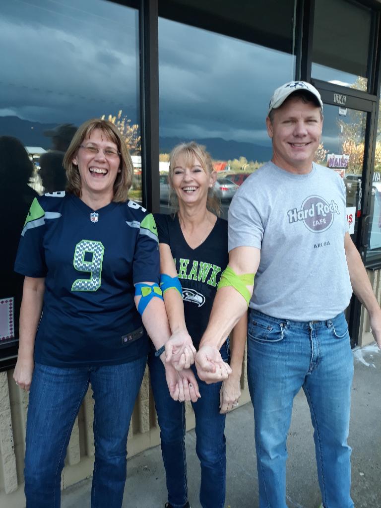 Three people with Blood Drive bandaids