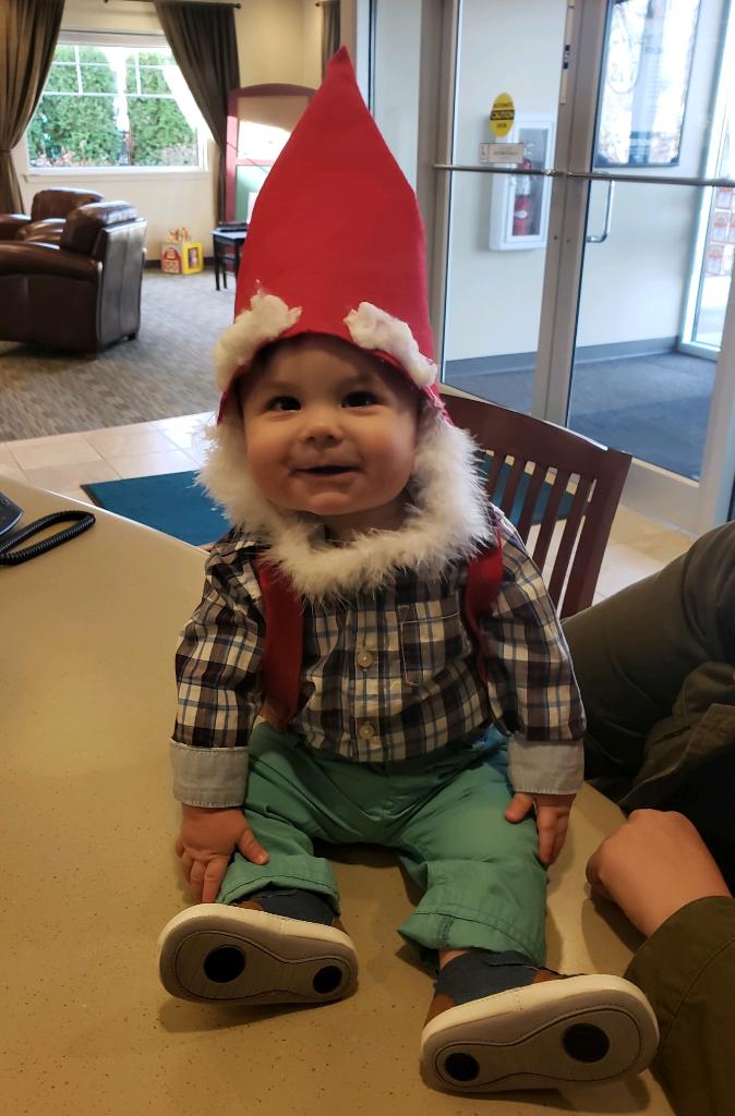 Baby member dressed up on Halloween sitting on a table at White River Credit Union
