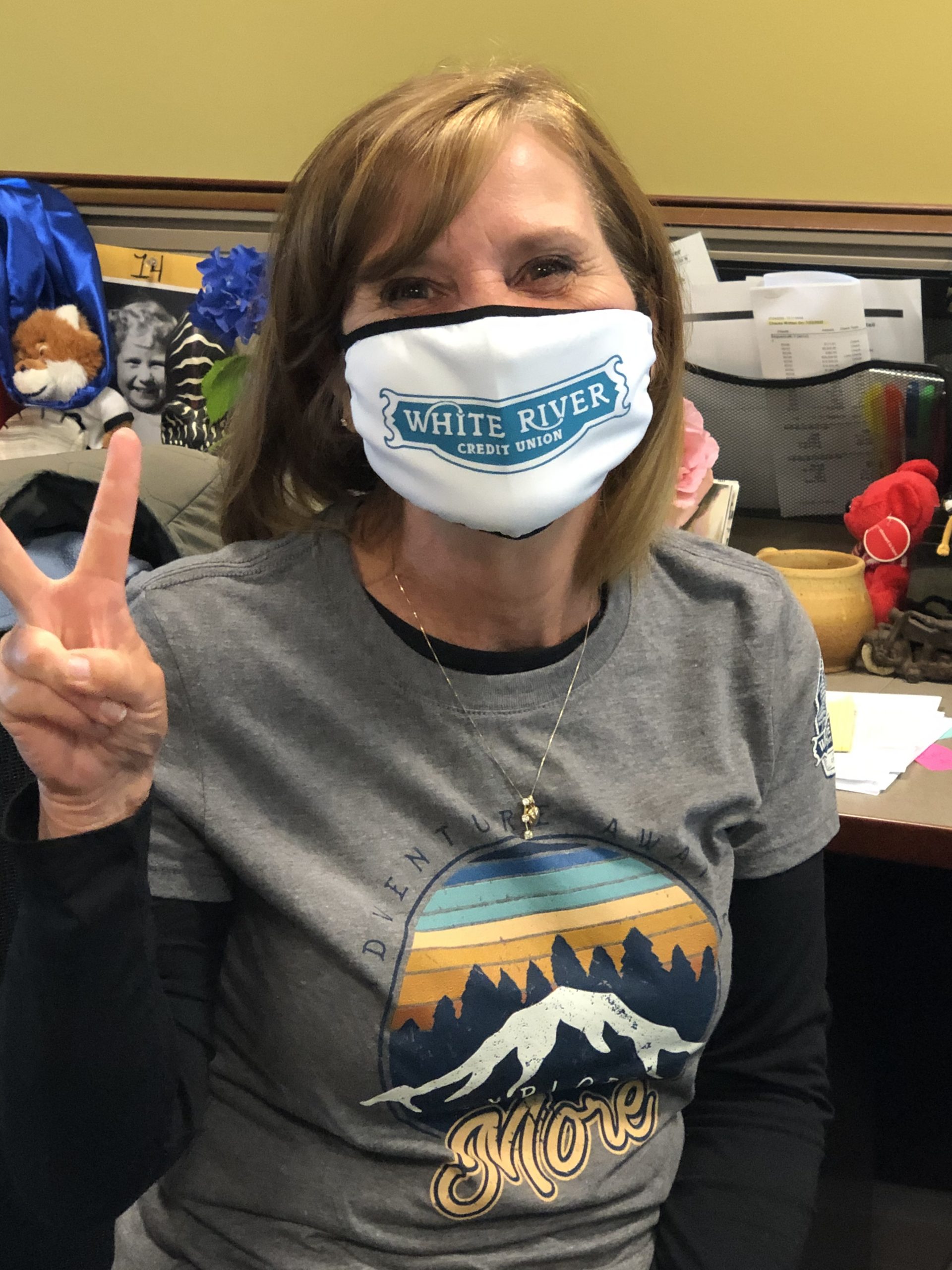 White River Credit Union employee making a peace sign and wearing mask