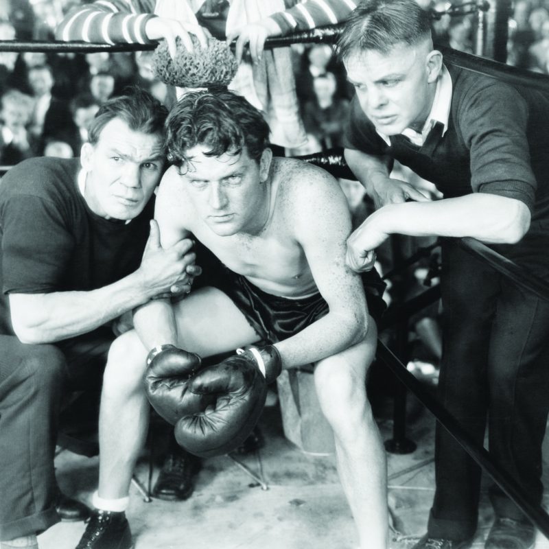 Boxer in corner with two coaches