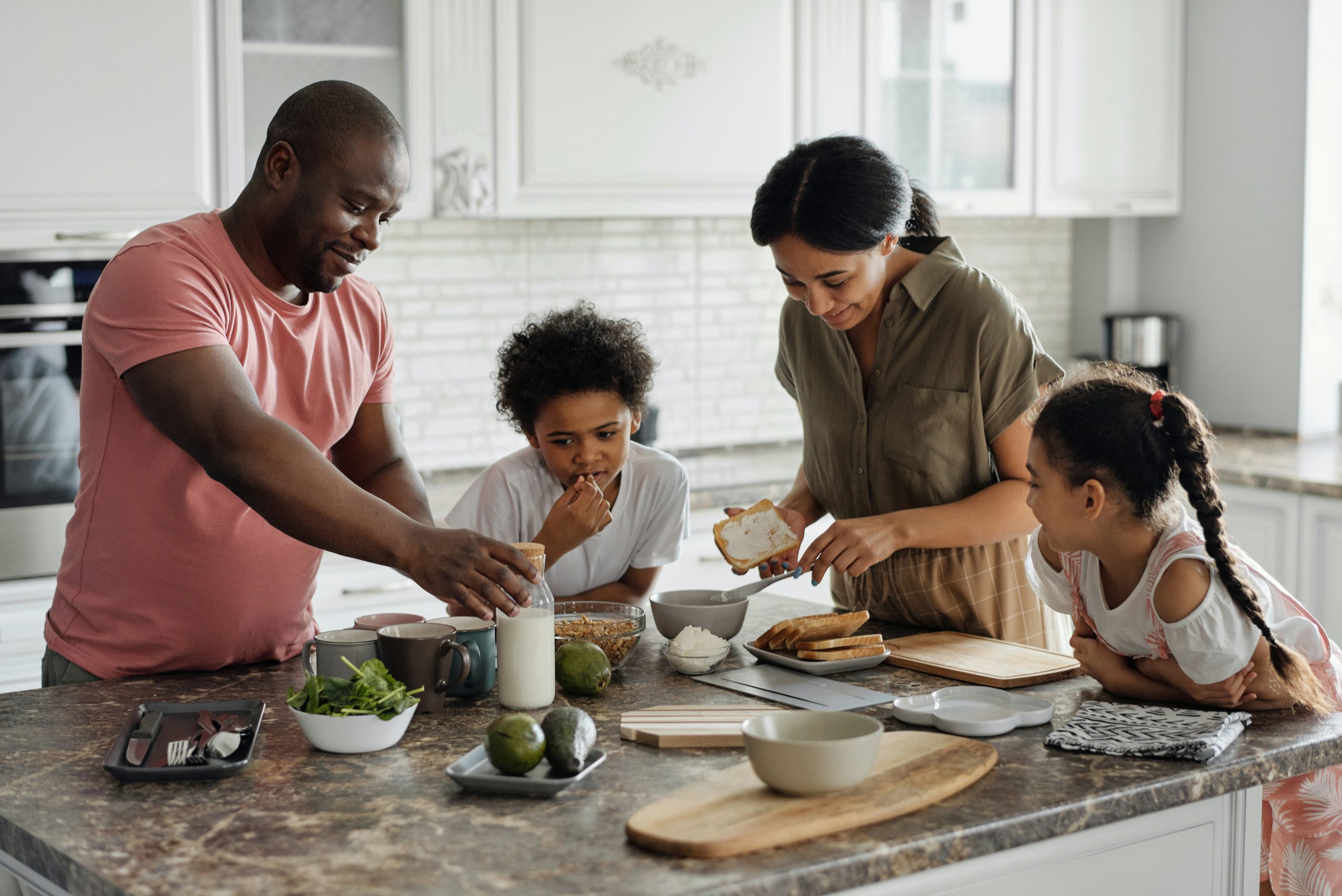 A family gathered around a kitchen island discussing insured deposits and eating