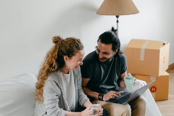 A couple sitting in their new home while financial planning