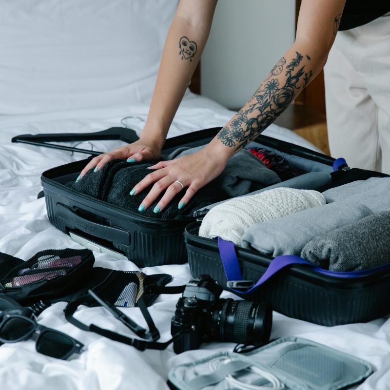 Someone packing their suitcase on a blog about travel insurance