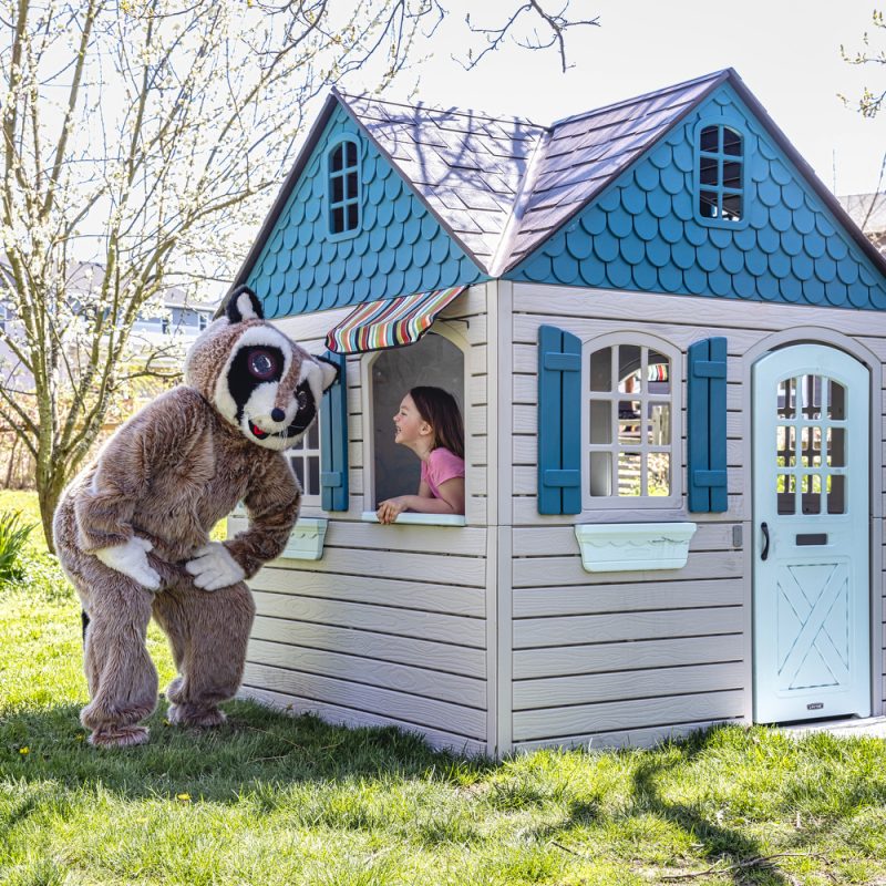 A raccoon mascot and a girl laughing in a playhouse on a HELOC blog