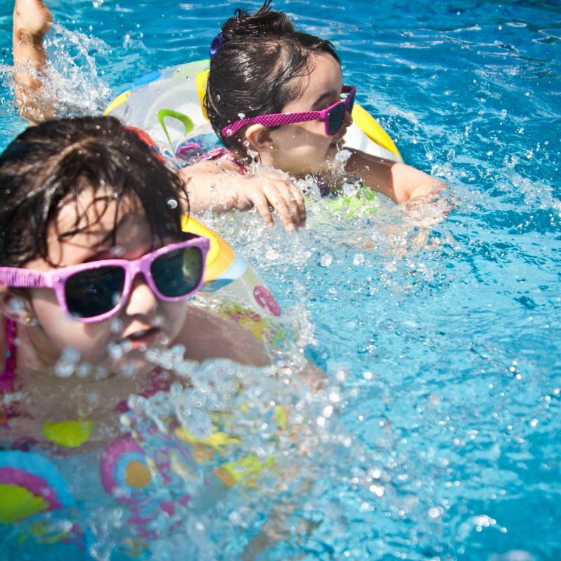 Floating in the pool on a blog about summer vacation budgeting