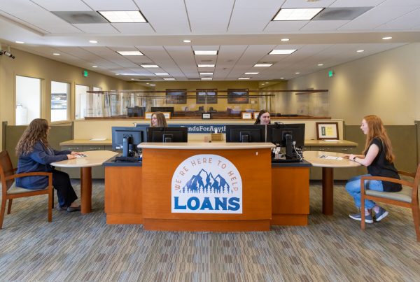 Two credit union members asking financial questions