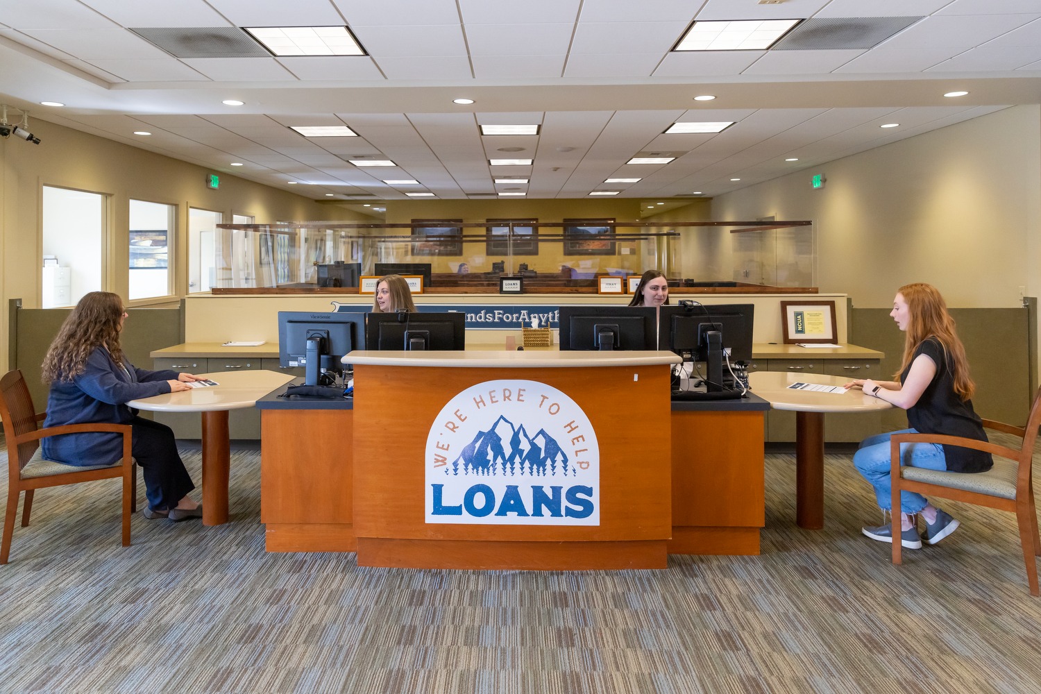 Two credit union members asking financial questions