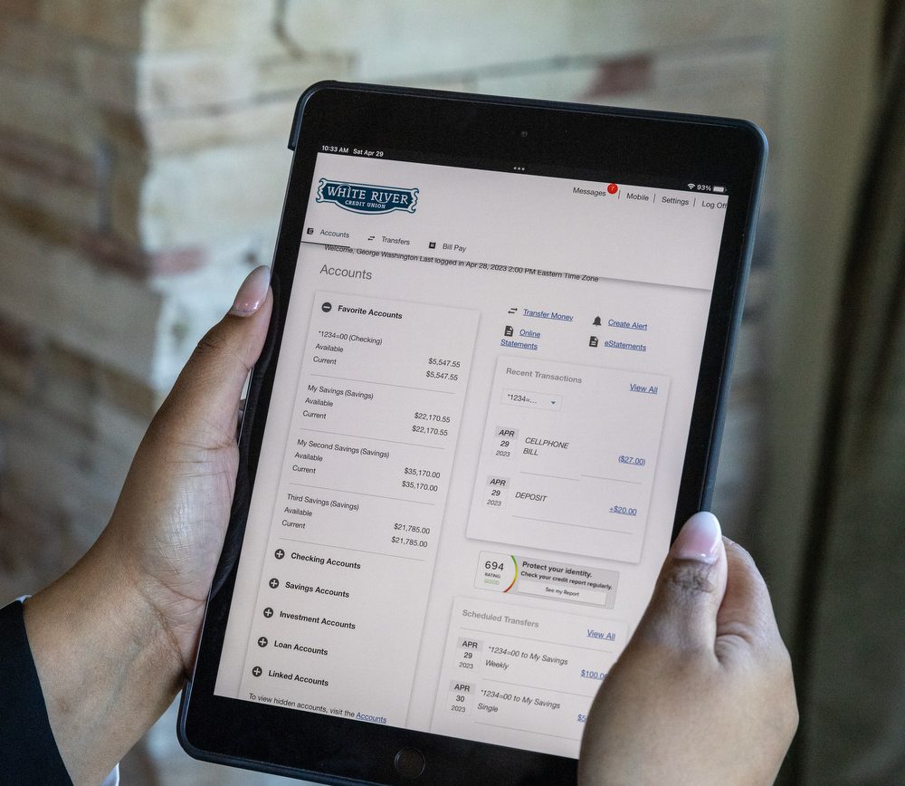 Photo of a person holding an ipad with a online banking security feature